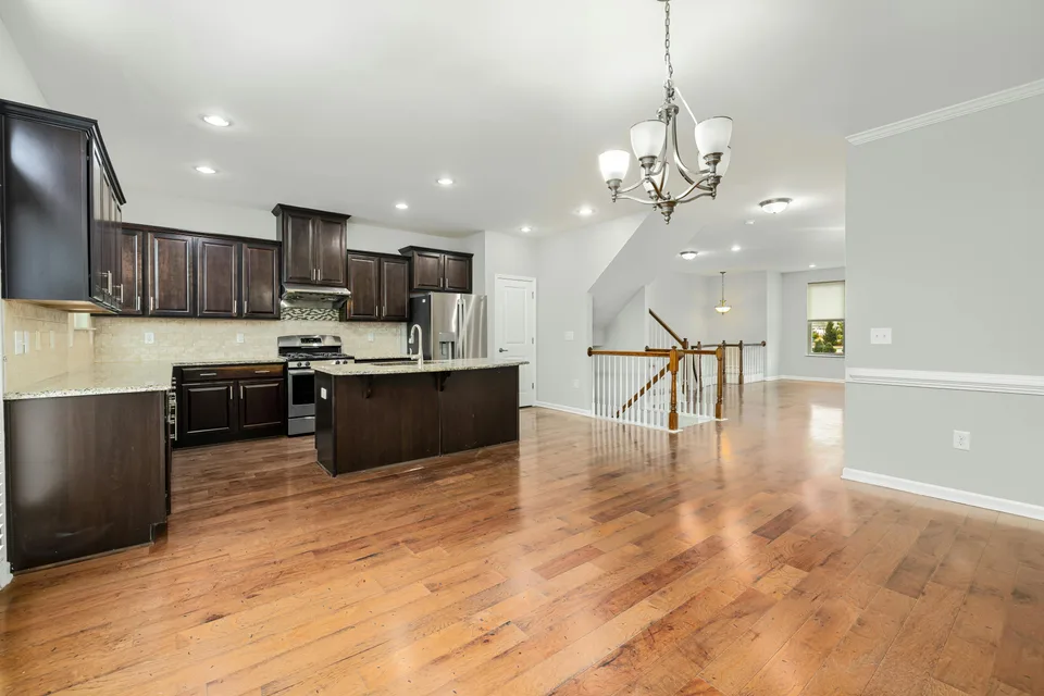 Open-plan kitchen and living room with new hardwood flooring
